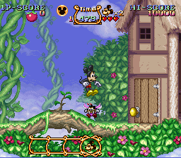 Mickey salta sobre um inimigo na primeira fase — SNES